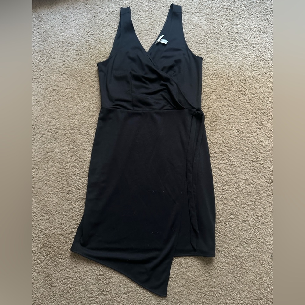 NWOT. A new day. Black asymmetrical wrap, tie on the side dress.